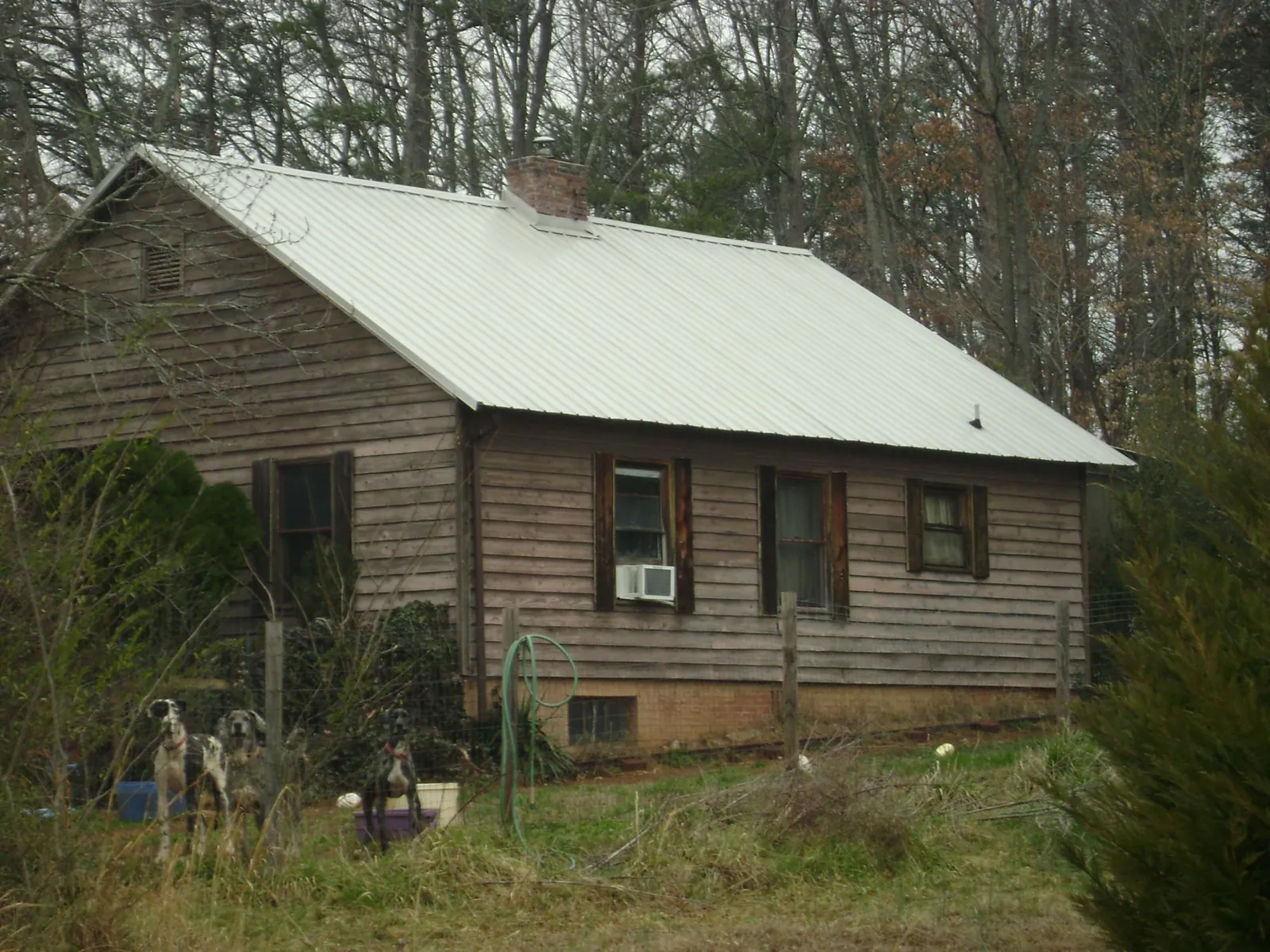 White metal roof on an old wood sided farmhouse, from a Asphalt Shingle Roof Repair job in Suitland